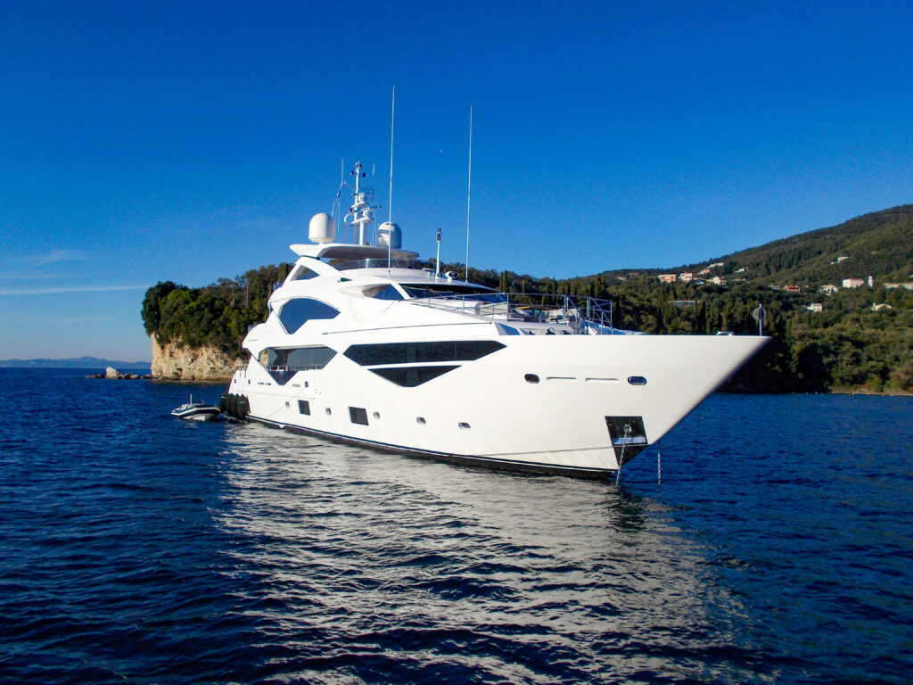 White superyacht anchored in open water
