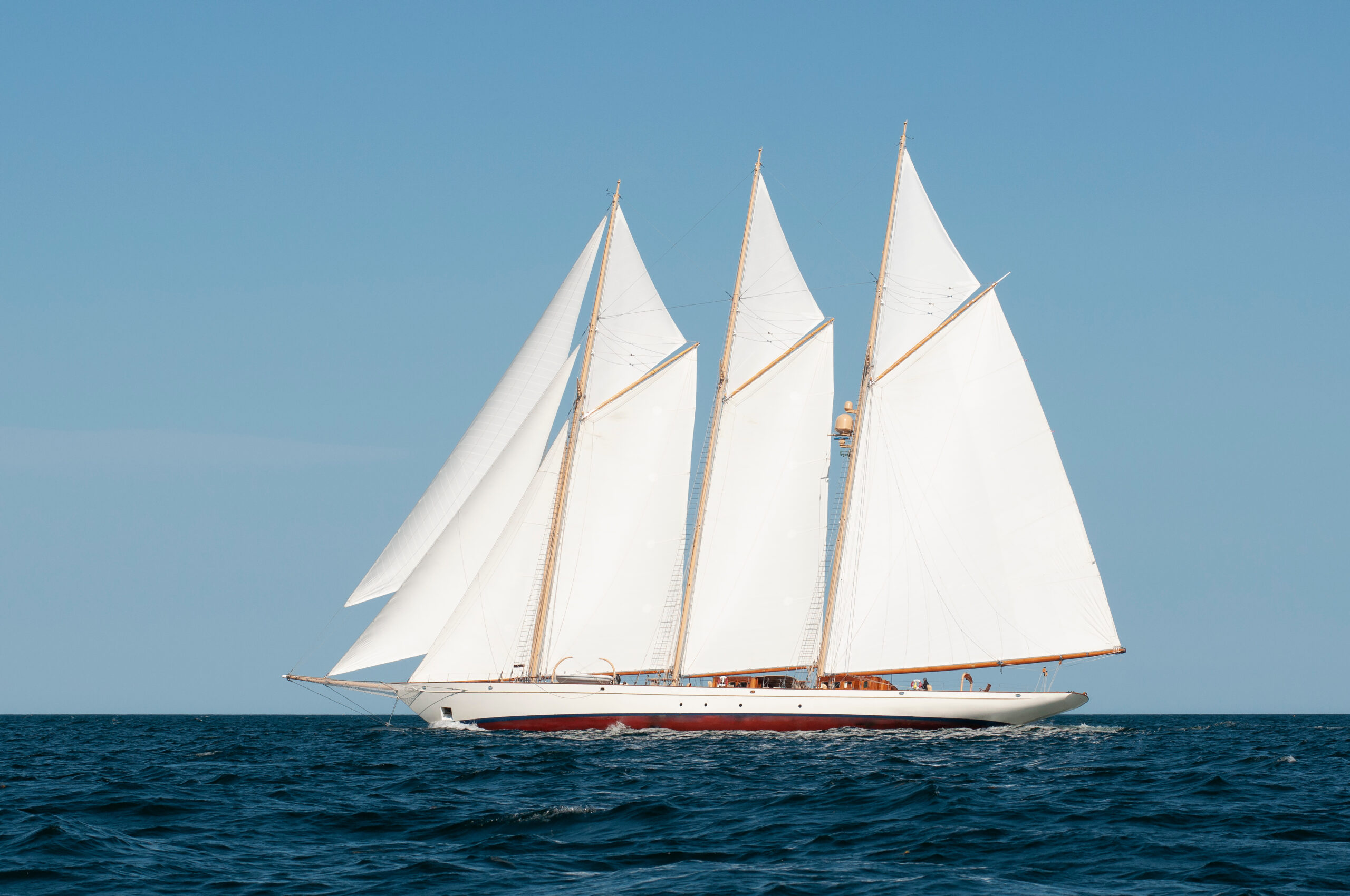 Three-masted schooner under full sail off the coast of Maine