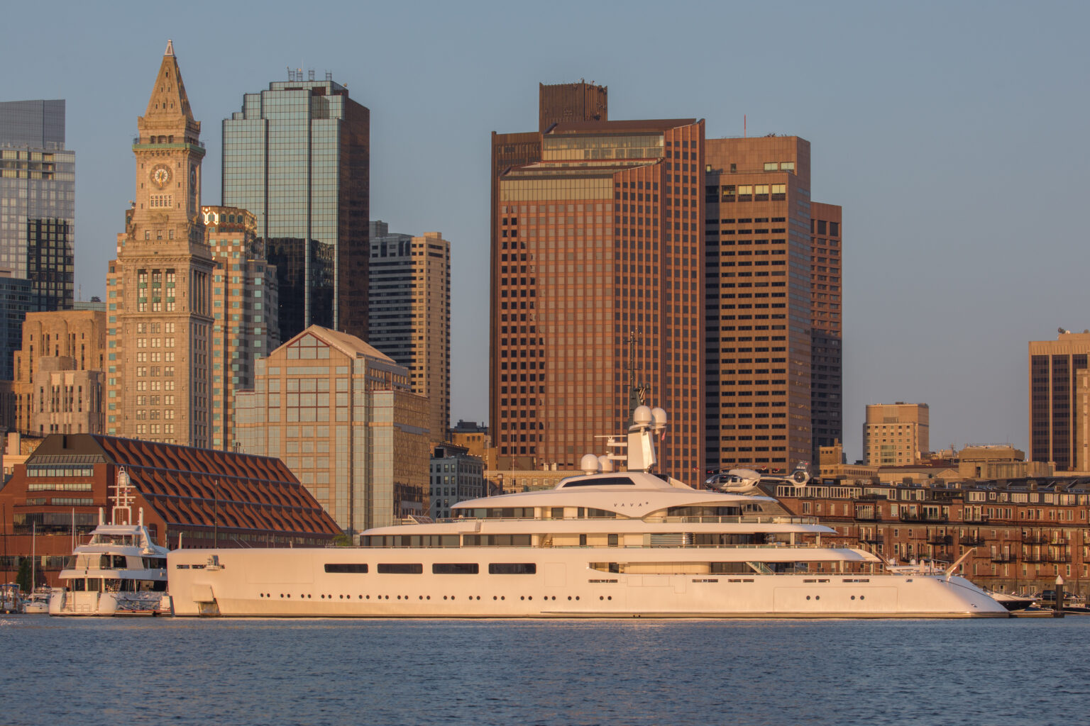 Superyacht alongside in Boston Harbor below the city skyline