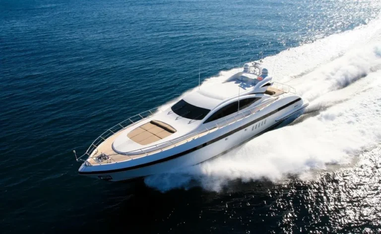 Motor yacht under way at speed, leaving a wake