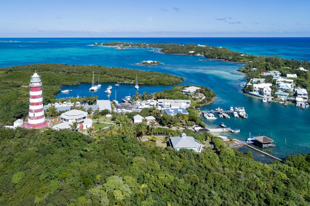 The candy-striped Elbow Reef Lighthouse above Hope Town harbour, Abaco