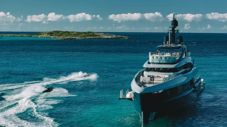 Superyacht at anchor with tenders and water toys alongside