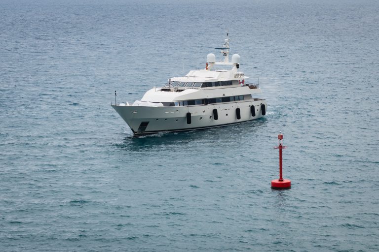 A white motor yacht cruising off the coast of Nice