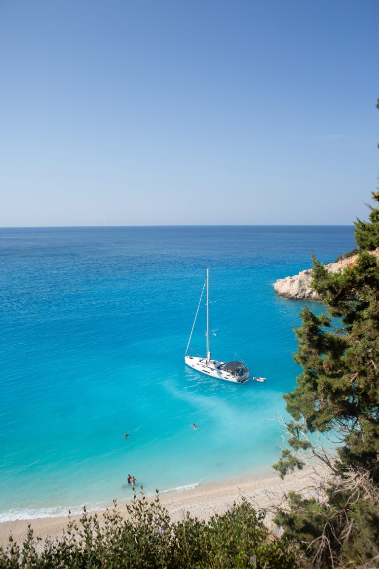 A sailboat at anchor in turquoise water off Porto Katsiki, on Lefkada