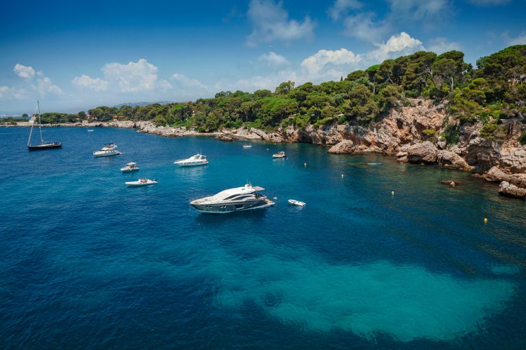 Boats at anchor below the rocks of Cap d'Antibes