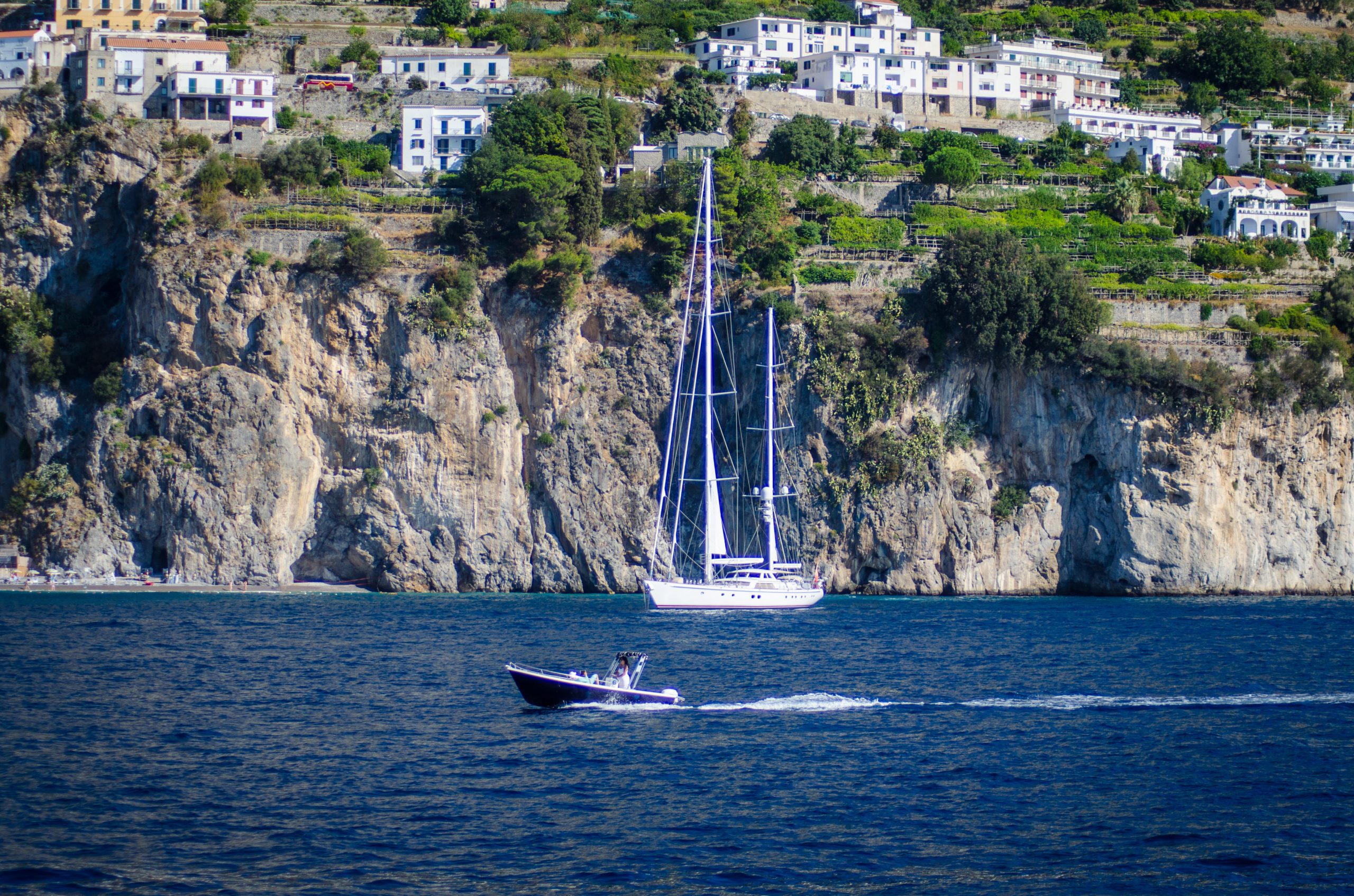 A sailing yacht under way off the Amalfi Coast in late summer